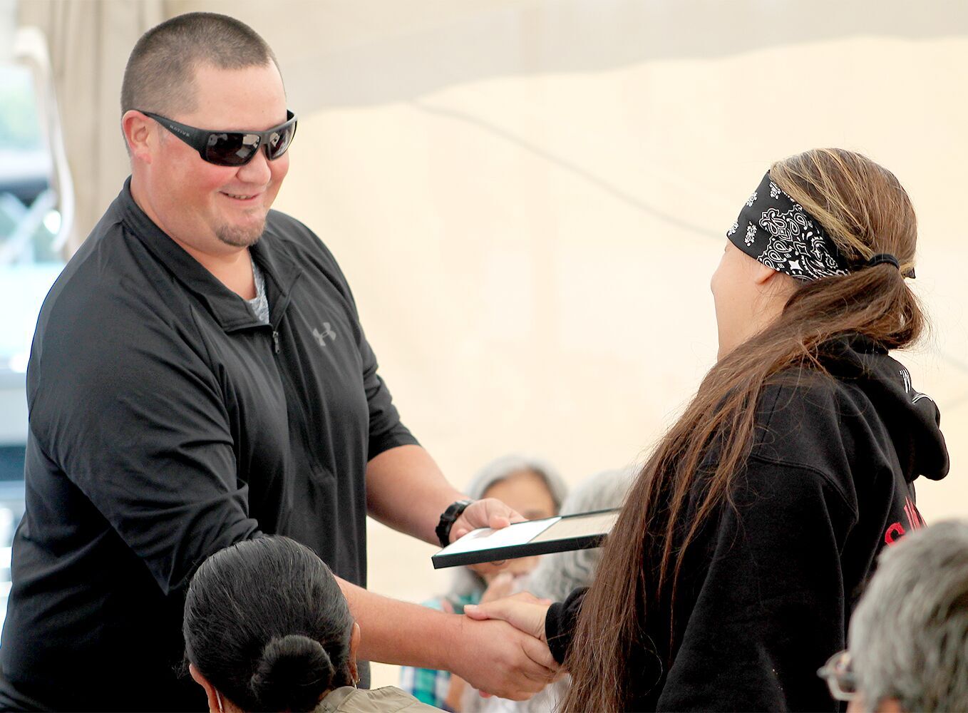 Tony Incashola, Jr. congratulates greenhouse employees